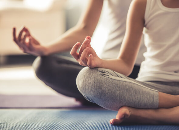 Mom and daughter doing yoga